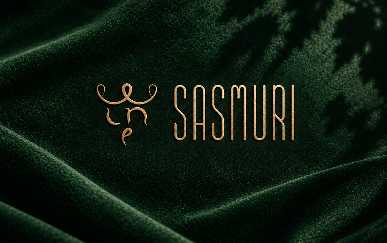 Sasmuri’s gold lettering and wine-glass emblem on green textured fabric